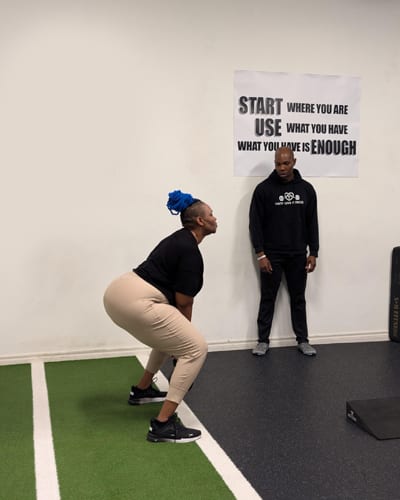 Gbenga coaching a client one-on-one at Built by Faith Love Fitness